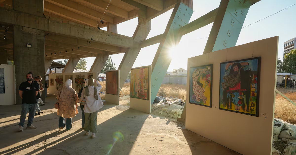 Visitors viewing paintings in the afternoon light at Masar Rose