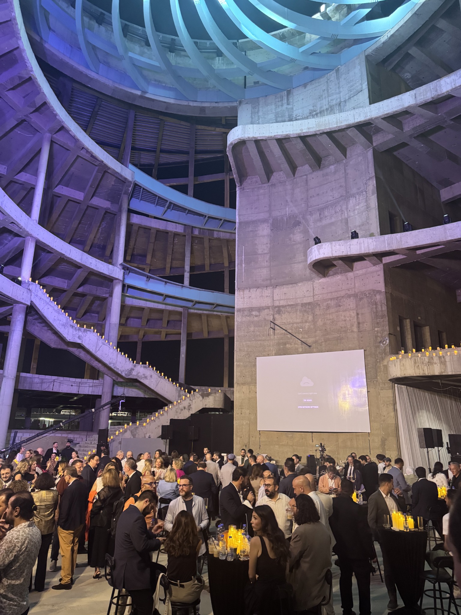 Illuminated architecture and guests inside Masar Rose