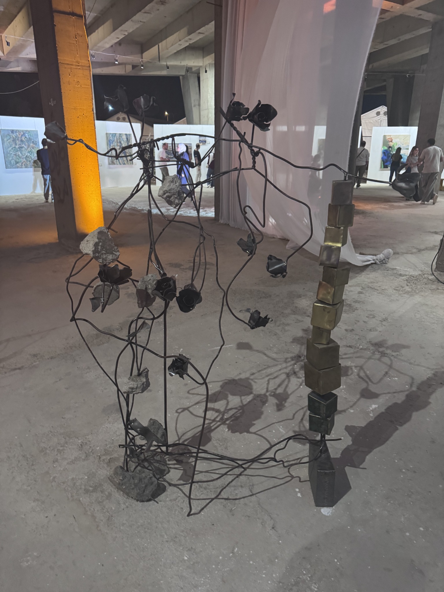 Sculpture displayed among paintings at Art Week Syria