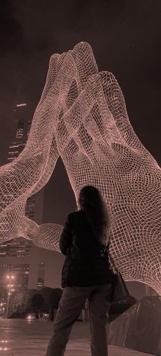 Line Kouwatli in front of an illuminated artwork
